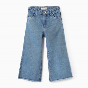 Pantalón vaquero azul para niña, corte Wide Leg, con bajos deshilachados y cintura ajustable.